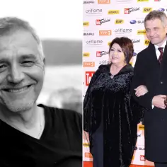 Uśmiechnięty Ryszard Sibilski, znany z roli w "Raku", na tle ścianki z logotypami. Obok niego stoi kobieta w czarnym płaszczu.